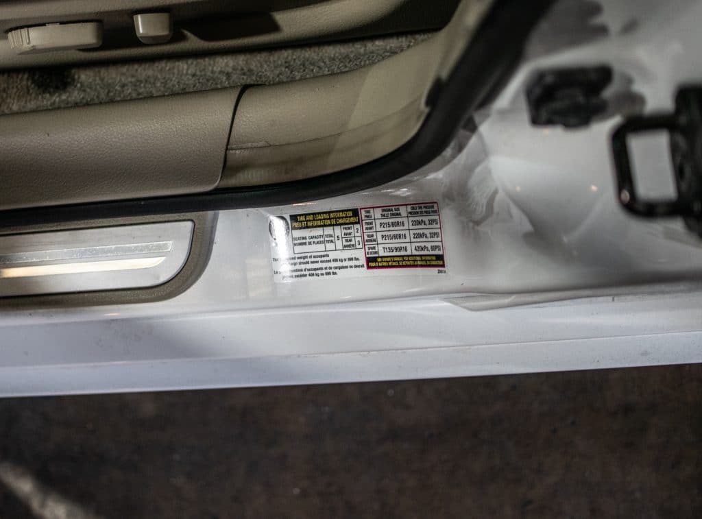 Tire pressure and size sticker on the driver door jamb